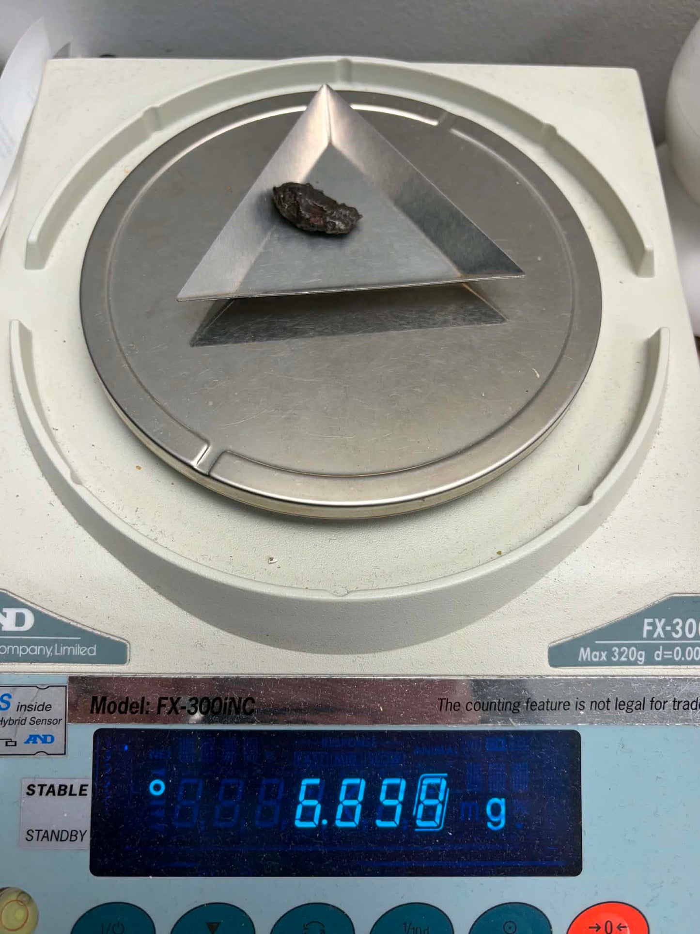 Sikhote-Alin iron meteorite 6.898g on precision scale reading 6.898g
