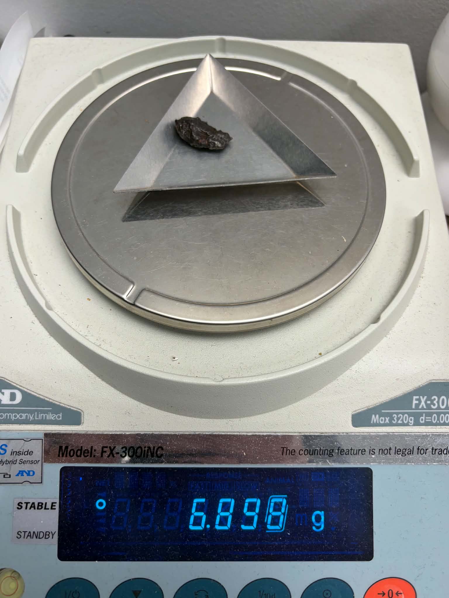 Sikhote-Alin iron meteorite 6.898g on precision scale reading 6.898g