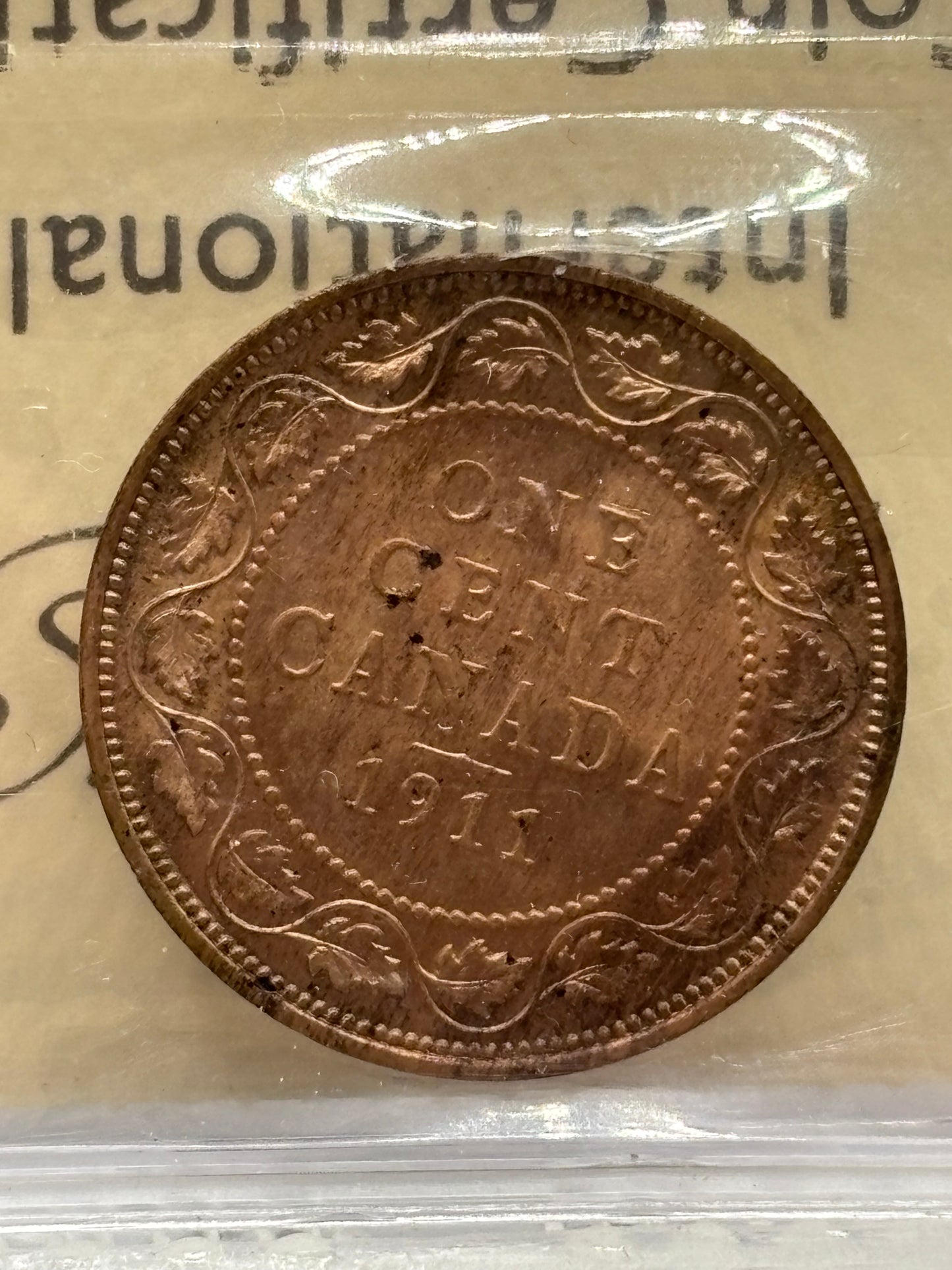 1911 Canada $0.01. ICCS graded MS-64 red.