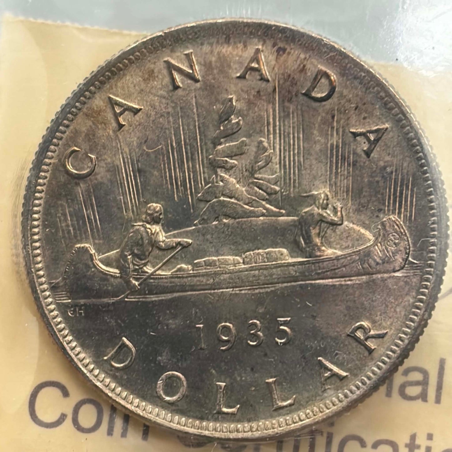 1935 Canadian Silver Dollar — reverse showing Voyageur canoe design 1935 DOLLAR in ICCS holder