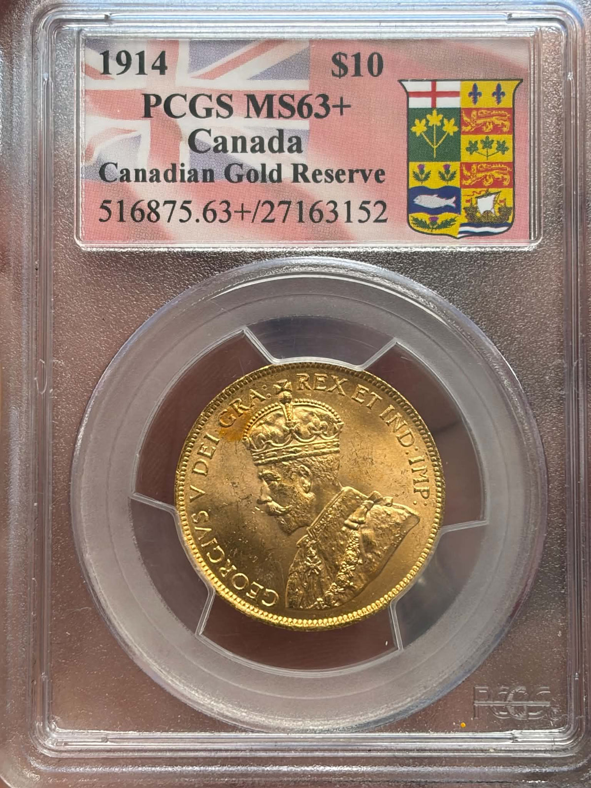 1914 Canada ten-dollar gold coin reverse with historic provincial shield and maple leaves in PCGS holder